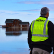 thumbnail image of a cass county official overlooking flood water