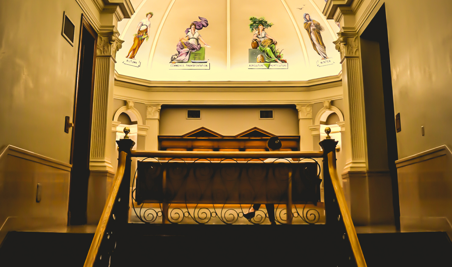 Image of a person sitting on a bench outside of the courtrooms in the Cass County Courthouse