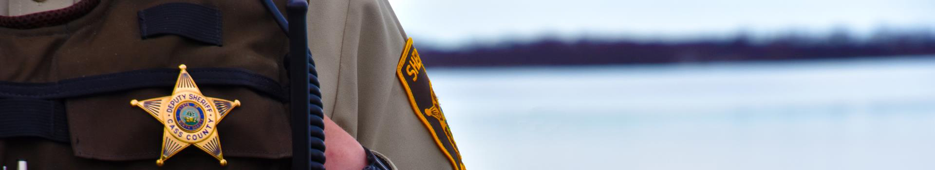 Banner image of deputy and his badge with the Cass County Sheriff's Office