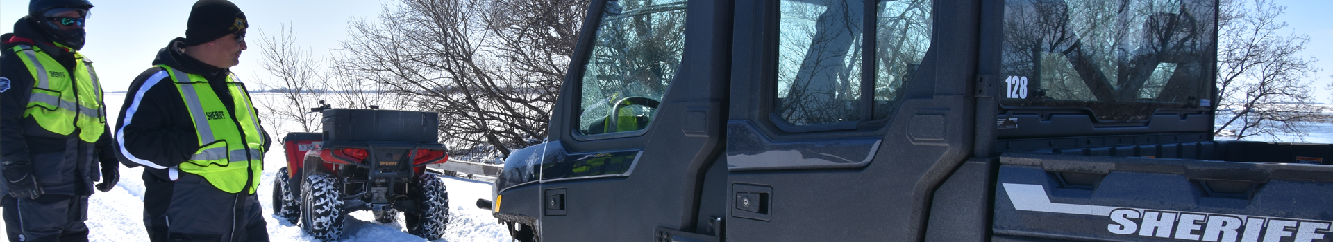 Banner image of two Sheriff's deputies standing next to a UTV