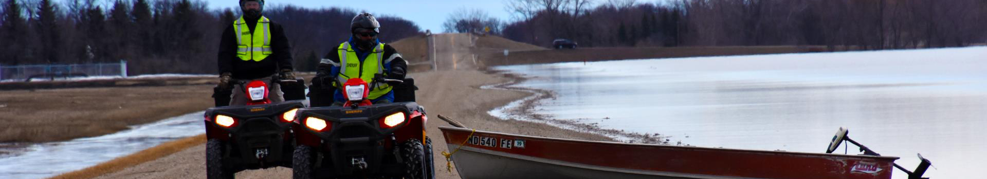 Banner image showing two Cass County officials responding to flood events