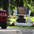 Image of a smartsign telling a car don't text and drive