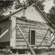 Image of Fargo's first house - a log cabin built in 1869 by Harry Moore and George Mann